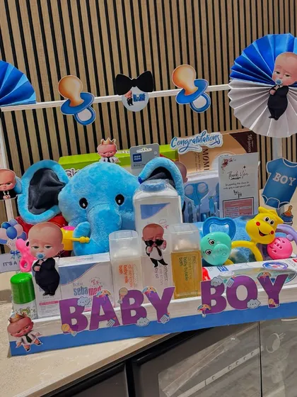 This Boss Baby themed hamper is perfect for welcoming a new baby boy. The blue elephant and pacifier garland add to the playful and cute design.