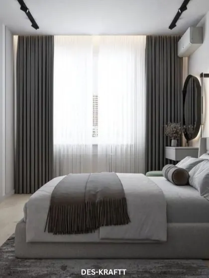 A modern bedroom design featuring a cool grey color palette, a comfortable upholstered bed, and a sleek, wall-mounted TV for a clean and uncluttered look.