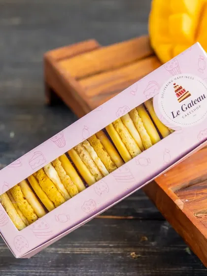 Bite-sized bliss. Our Mango Cheesecake Macarons have a crisp shell and a creamy mango cheesecake filling, capturing the essence of two of our favorite desserts in one bite.