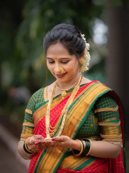 A moment of quiet reflection during the Vat Purnima ceremony. This portrait captures the woman holding items for the puja, her expression filled with devotion and peace.