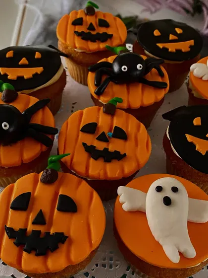 Spooky and sweet! These Halloween-themed cupcakes are decorated with jack-o'-lanterns, ghosts, and spiders, adding a fun and delicious touch to the celebration.
