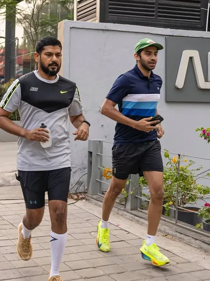 Two of our members running on the sidewalk, showing that our community takes their training seriously, both in and out of the park.