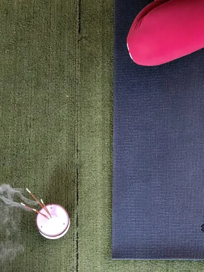A close-up of a yoga mat and incense, setting the mood for a calming session. It's the small details that create a peaceful and focused environment.