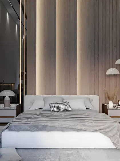 This modern bedroom design uses vertical wood slats and integrated LED lighting to create a warm and inviting feature wall. A large mirror enhances the sense of space.