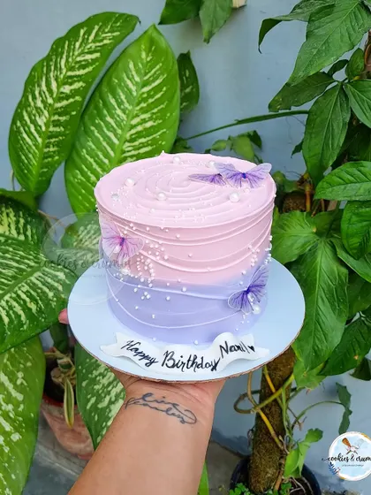 My butterfly and ombre cakes are a customer favorite. The gradient of colors, delicate butterflies, and pearl details create a dreamy and elegant look for any occasion.