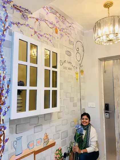 Posing with some flowers that match the mural's color palette. It was a joy to create this warm, serene landscape to welcome visitors.