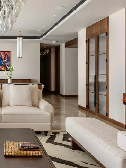 Another view of the Parishram living room, showing the arrangement of the sofas and the strategic placement of art to create a balanced and harmonious composition.