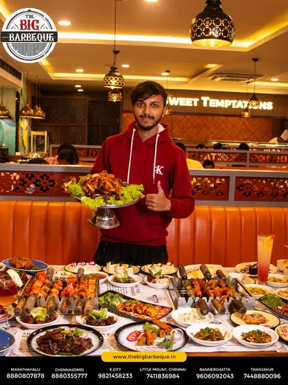 Delight on every plate. A happy guest gives a thumbs up, surrounded by our lavish buffet, showcasing the joy we bring to your table.