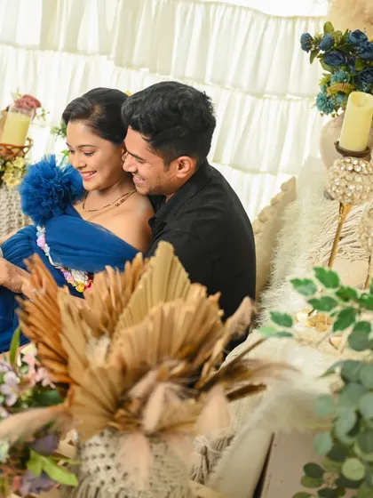 A cozy and romantic studio moment. The rich blue gown and the soft lighting create an intimate atmosphere for this couple's portrait.