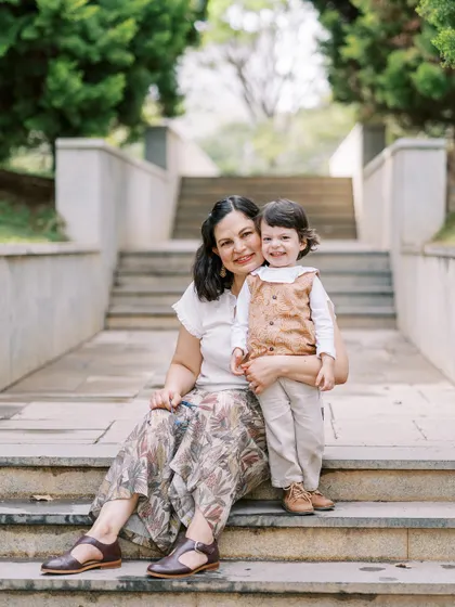 A mother and son sitting on stone steps in the park. Even a simple location can be the perfect spot for a beautiful portrait.