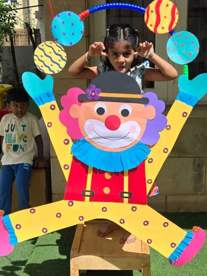 Making silly faces behind the giant clown craft! We believe learning and creativity should always be filled with laughter and fun.