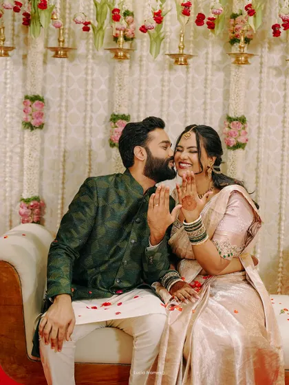 A sweet kiss on the cheek amidst the celebration, a candid moment of affection.