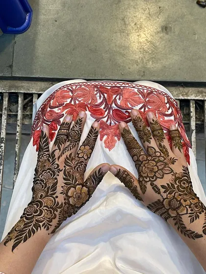 A beautiful example of guest mehndi with a full-coverage floral vine pattern on the back of the hands. This style is very popular for its elegance and intricate look.