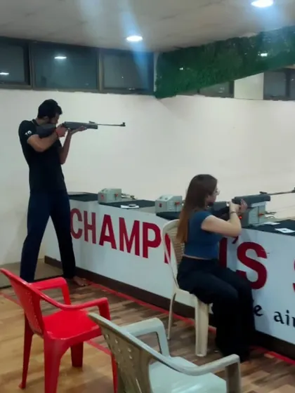 We offer both standing and seated positions to ensure everyone can participate comfortably. Here, two shooters practice side-by-side at our Andheri range.