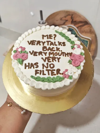 Sometimes you just need a cake that says it all. This custom cake features a funny, sassy quote piped on top, surrounded by a floral border.
