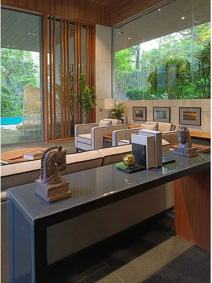 A view from the pantry-bar into the lounge, showing how carefully chosen artifacts like chess pieces and books are used to accentuate the space.