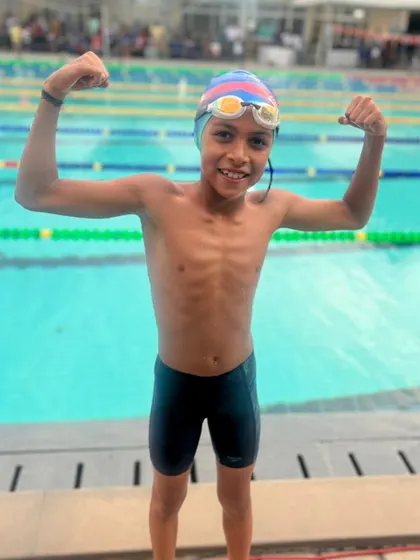Sudhanva Y flexing after winning a Bronze Medal in the 200m Individual Medley. This challenging event requires skill in all four strokes, a core part of our curriculum.