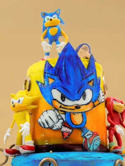A detailed shot of the hand-painted Sonic on the top tier, showcasing the artistic effort that goes into these character cakes.