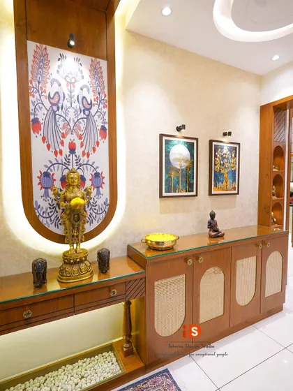 A closer look at the traditional foyer console, highlighting the custom backlit panel with Indian folk art, the elegant brass statue, and the cane-fronted cabinets.