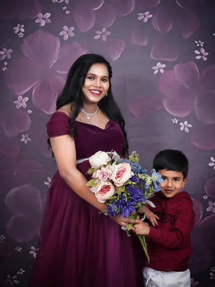 A sweet studio moment between a mother-to-be and her son. Including your children in your maternity photoshoot helps capture this unique moment in your family's story.