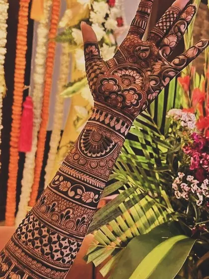 A lovely Madhubani-style design with a focus on floral patterns on the back of the hand.