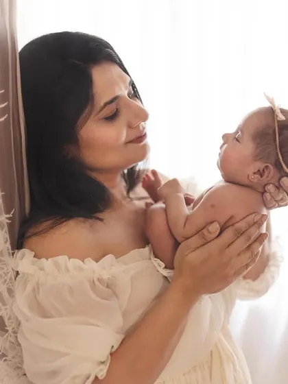 A mother's loving gaze at her newborn baby, captured in soft, natural light. These are the quiet, fleeting moments of early motherhood that I aim to make eternal.