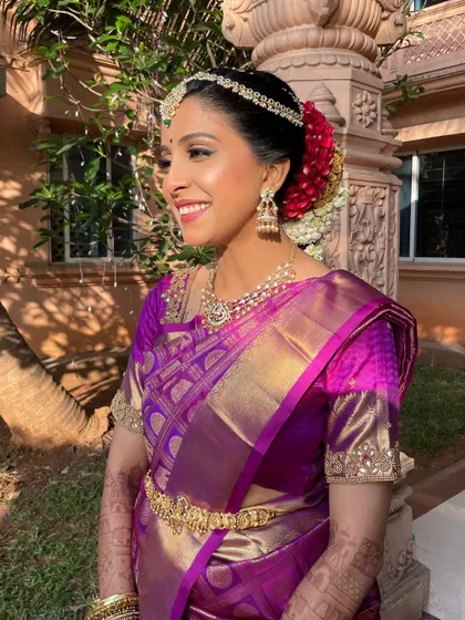 A candid, happy moment. The sunlight catches her highlighter beautifully, showcasing that perfect bridal glow that every bride dreams of.