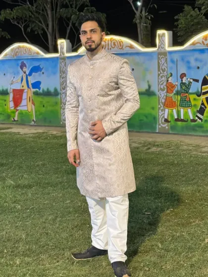 A full-length view of the beige ethnic sherwani. It's a classic and elegant choice for any traditional wedding ceremony.