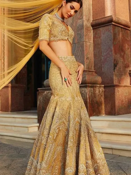 The mermaid-style lehenga is a fantastic choice for a reception. I can create a similar silhouette for you, embellished with intricate work for a truly glamorous feel.