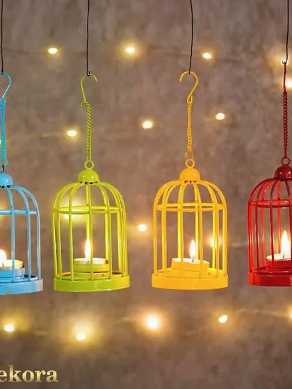 A set of four colorful hanging candle holders shaped like miniature birdcages. These are a fun and whimsical option for decorating an informal space or for a themed corporate event.