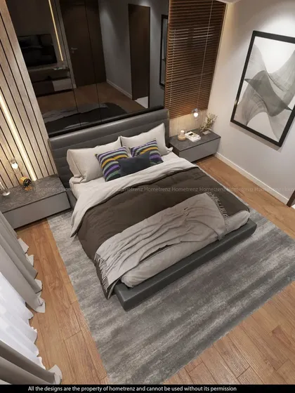 An overhead view of a master bedroom, showing a grey-toned rug, a bed with a simple headboard, and a TV unit against a fluted wood wall.