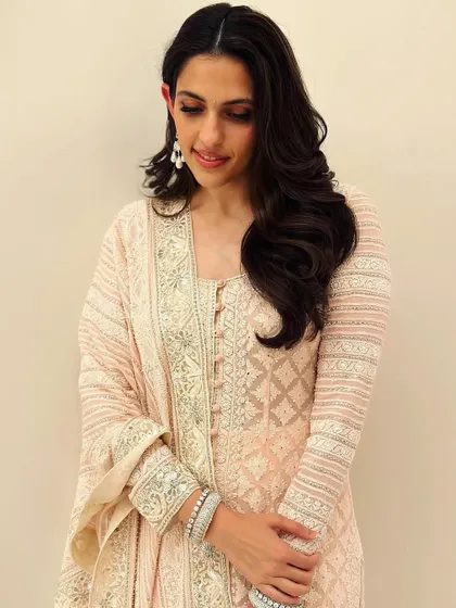 A closer look at the intricate chikankari work. The delicate white-on-peach embroidery is simply stunning.