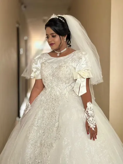 A close-up of Rachel's gown, showing the delicate embroidery on the bodice and the elegant bow detail on the sleeves. It's these small touches that make a dress unique.