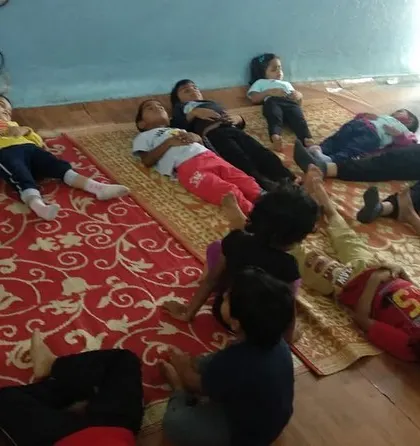 A large group of children practicing a relaxation pose. Learning to relax and be quiet is a valuable skill in today's busy world.