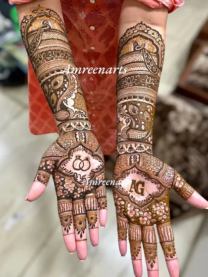 A full view of an engagement design, combining initials, rings, and peacock motifs.