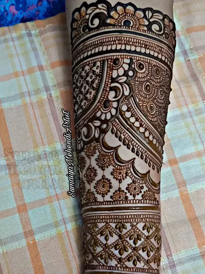 A full arm design with a mix of traditional Indian patterns, perfect for a bride.