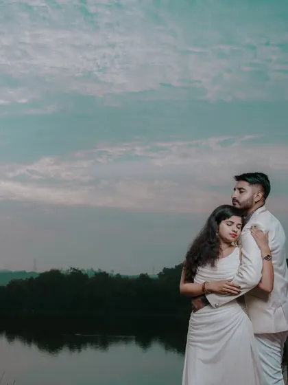 A quiet, intimate pre-wedding moment captured by the lake as the sun sets. We find the most serene natural locations for your photoshoot.