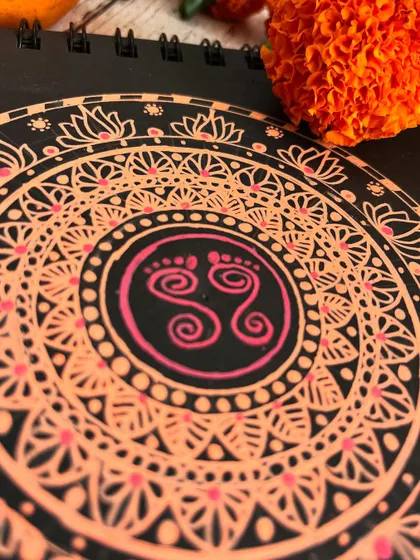 This orange mandala with divine footprints was created for the third day of Navratri, honoring Maa Chandraghanta, who symbolizes courage and tranquility.