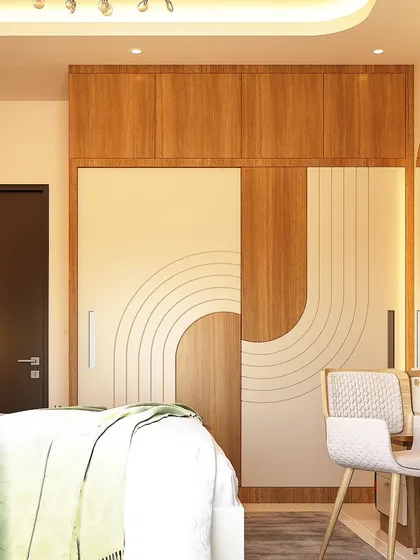 This sliding wardrobe features a unique geometric pattern that spans across the doors. The combination of wood grain and off-white panels, along with an integrated dressing table, creates a modern and cohesive look.