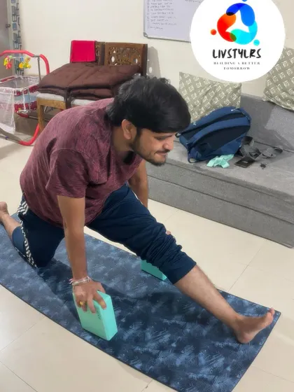 A client works on his flexibility with a supported runner's lunge, using blocks to make the deep stretch more accessible.