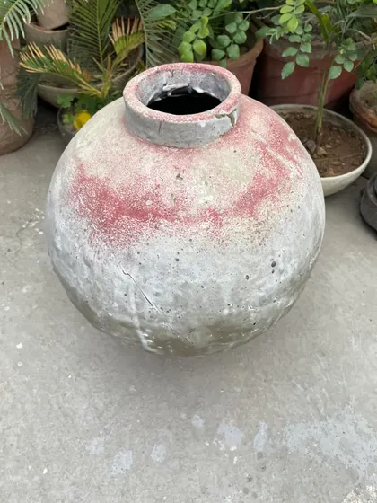 An old pot sitting in my garden. I love seeing how my pieces age and interact with the environment, gathering moss and character over time.