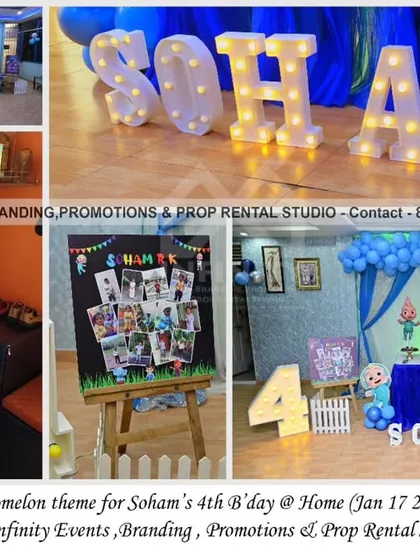 This Cocomelon theme for a 4th birthday at home features a blue color scheme with a curtain backdrop, balloon garland, and a milestone photo board. The large marquee letters add a bright and celebratory feel to the home setup.