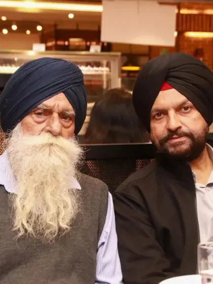 Two senior family members posing for a photo. We make sure to honor the elders of the family by capturing their portraits.