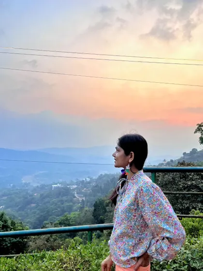 Looking out at the hazy mountains of Coorg at dusk. The soft, layered landscape is like a watercolor painting come to life.
