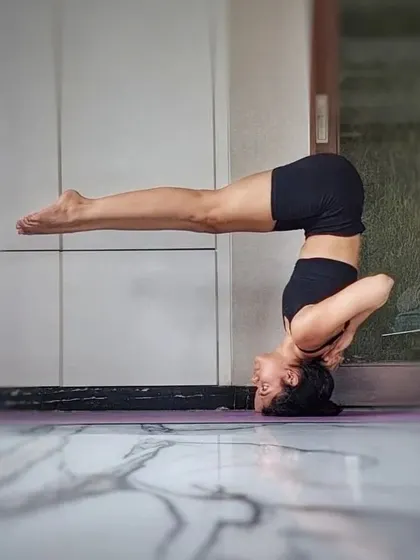 A straight-legged headstand variation. The key here is core engagement to maintain a straight line from the shoulders to the feet, building incredible inner strength.