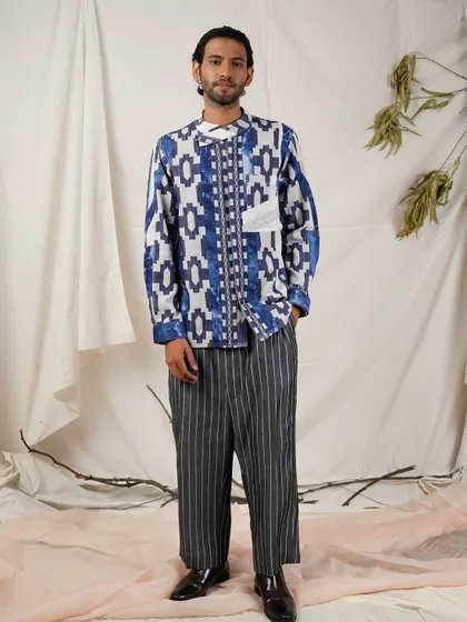 This full-length shot displays the complete outfit, pairing the printed kurta with striped trousers. It demonstrates how to style a statement piece for a cohesive and fashion-forward look.
