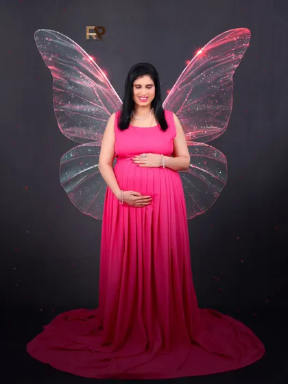 A touch of fantasy. We added these delicate, glowing butterfly wings to complement our client's flowing pink gown, creating a whimsical and magical portrait.
