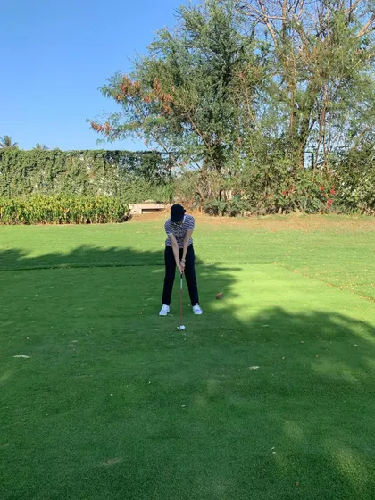 A student takes her practice to the course. Getting on the green and experiencing real playing conditions is a crucial part of my coaching philosophy.