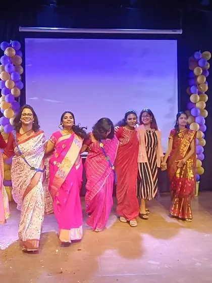 Our teachers enjoy a dance performance on stage, a fun moment from their special day of celebration.