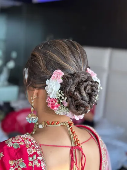 A beautiful floral bun for a Phera ceremony. I used a mix of pink and white flowers to create a soft, romantic look that complements the bride's pink lehenga.